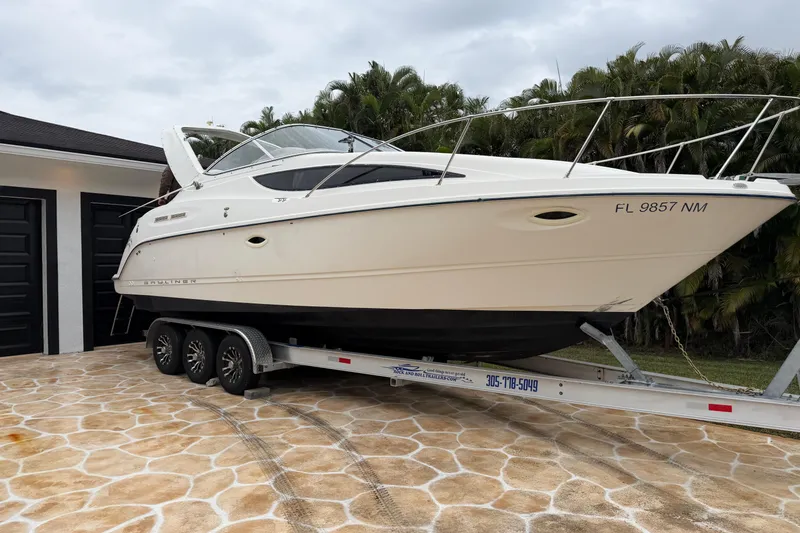 The Image of 2003 Bayliner 2855 Ciera boat on trailer under clear blue sky. - 0