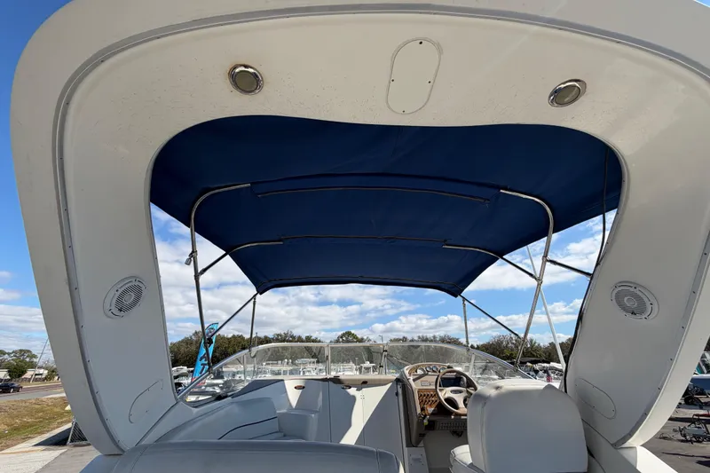 Slide: The Image of 2003 Bayliner 2855 Ciera boat interior with blue canopy and steering area. - 12
