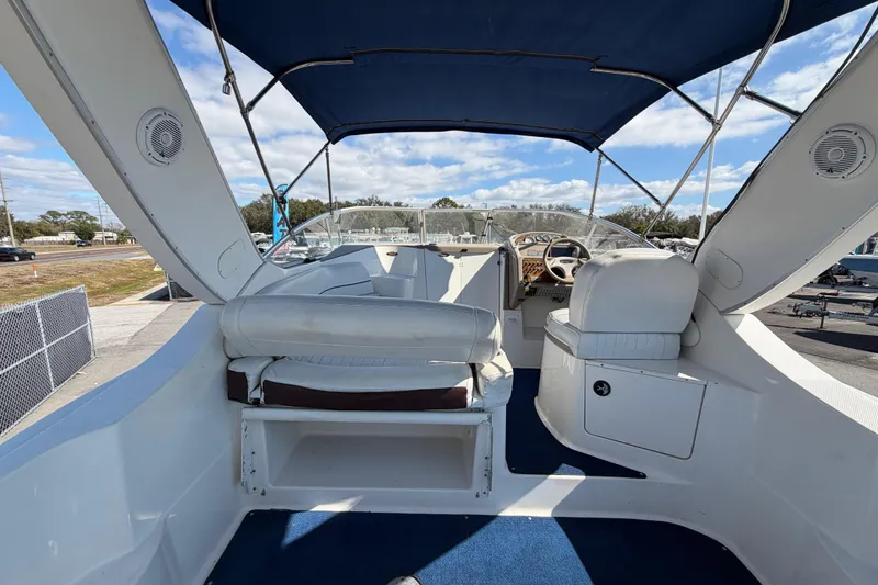 Slide: The Image of 2003 Bayliner 2855 Ciera boat interior with blue canopy and white seating. - 17