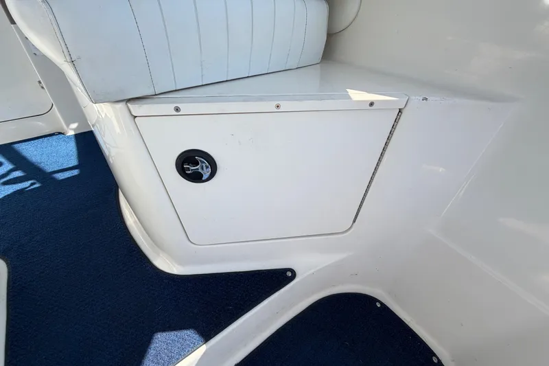 Slide: The Image of 2003 Bayliner 2855 Ciera interior storage compartment with blue carpet. - 19