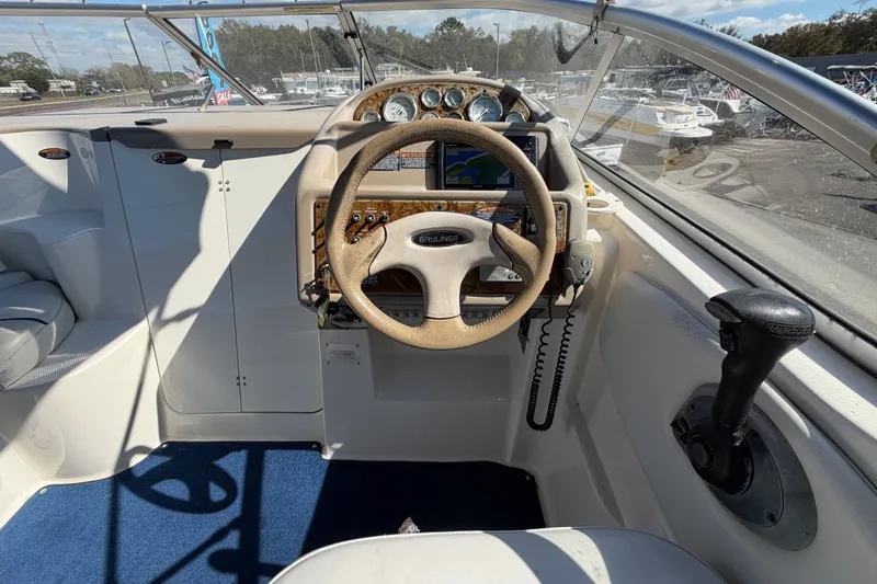 Slide: The Image of 2003 Bayliner 2855 Ciera boat cockpit with steering wheel and navigation controls. - 22