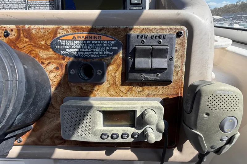 Slide: The Image of Control panel of a 2003 Bayliner 2855 Ciera boat with warning label and radio equipment. - 26