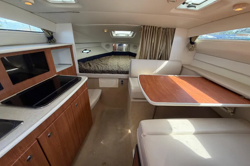 Slide: The Image of Interior of 2003 Bayliner 2855 Ciera boat with kitchen, dining area, and bed. - 30