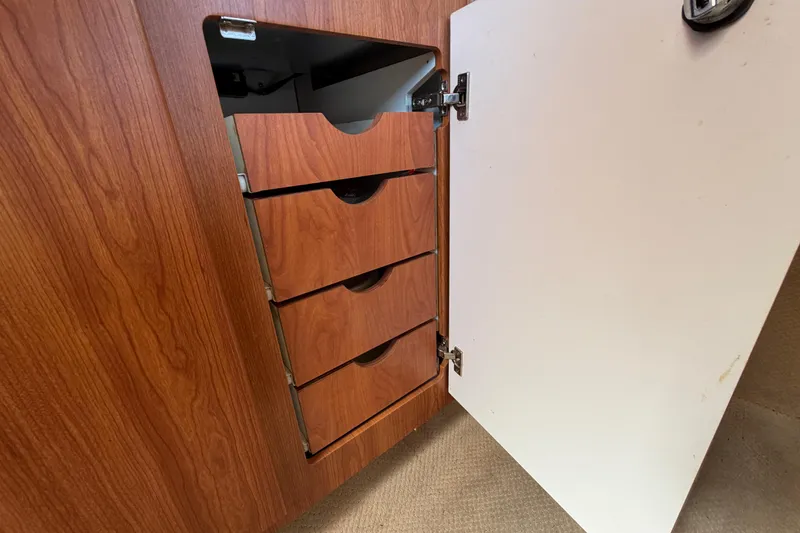 Slide: The Image of Wooden cabinet with open door revealing four drawers in 2003 Bayliner 2855 Ciera. - 36