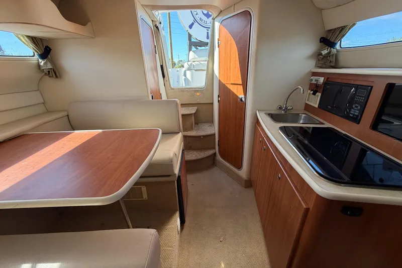 Slide: The Image of Interior of 2003 Bayliner 2855 Ciera boat with kitchen and dining area. - 38