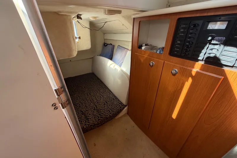 Slide: The Image of 2003 Bayliner 2855 Ciera cabin interior with wood cabinetry and cozy sleeping area. - 40