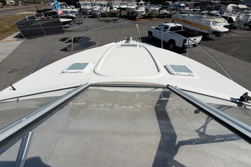 Slide: The Image of 2003 Bayliner 2855 Ciera boat on display at a marina with parked vehicles. - 41