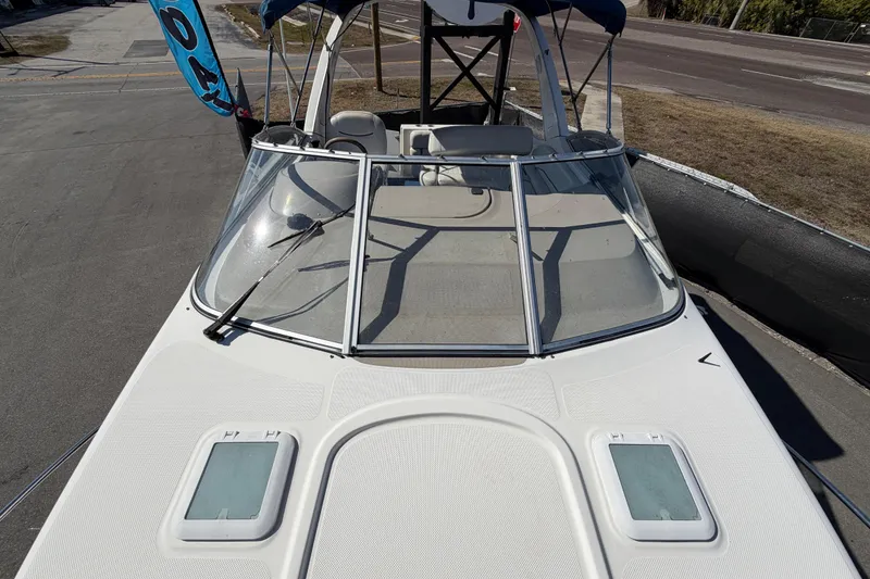 Slide: The Image of 2003 Bayliner 2855 Ciera boat with windshield and deck view, parked on pavement. - 45