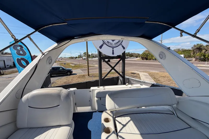Slide: The Image of 2003 Bayliner 2855 Ciera boat interior with blue canopy and white seating. - 47