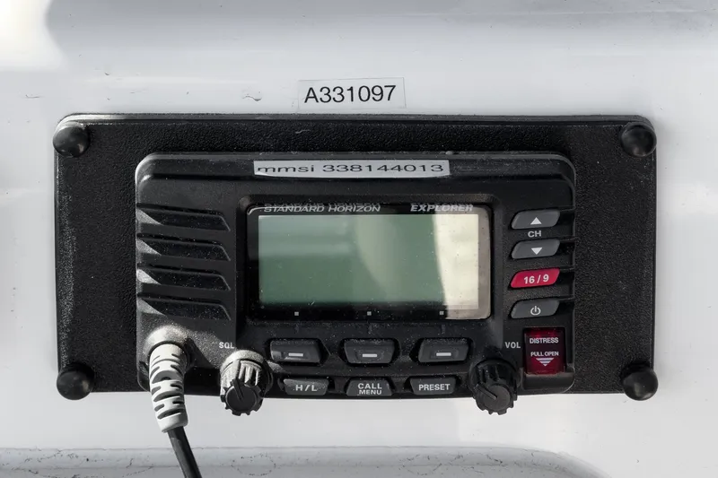 Slide: The Image of VHF radio on 2006 Riviera 33 Flybridge boat, displaying MMSI number. - 18