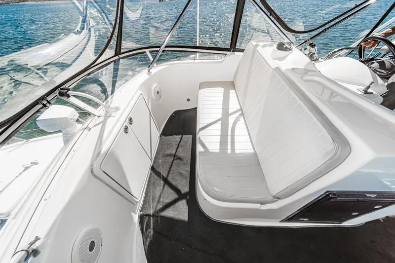 Slide: The Image of 2006 Riviera 33 Flybridge interior with white seating and panoramic windows. - 19