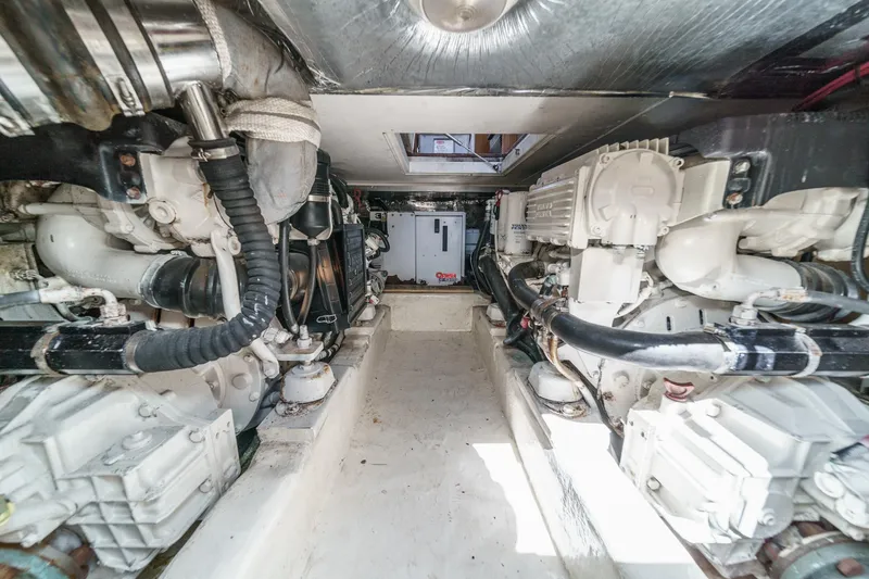 Slide: The Image of Engine room of 2006 Riviera 33 Open Flybridge, showcasing dual engines and mechanical components. - 2