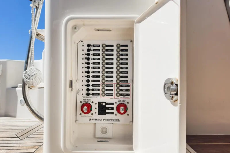 Slide: The Image of Riviera 33 Flybridge 2006 battery control panel with open compartment on deck. - 25