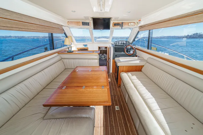 Slide: The Image of Luxurious interior of 2006 Riviera 33 Flybridge yacht with panoramic ocean views. - 27