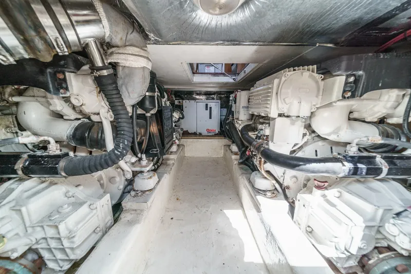 Slide: The Image of Engine room of 2006 Riviera 33 Flybridge yacht, showcasing dual engines and mechanical components. - 32