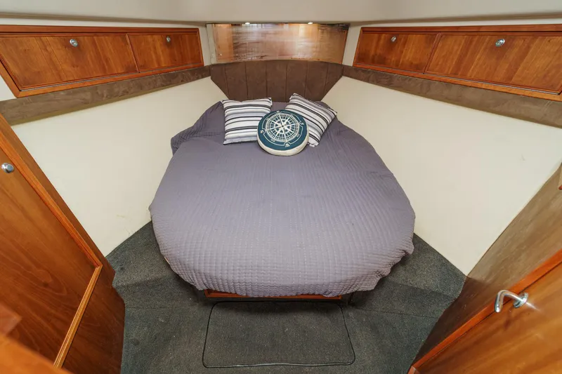 Slide: The Image of Cozy bedroom in 2006 Riviera 33 Open Flybridge yacht with nautical-themed decor. - 7