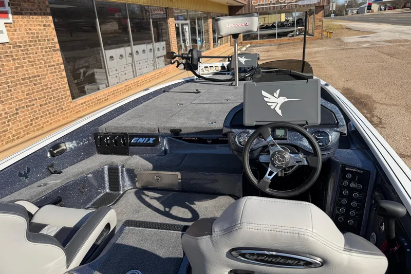 Slide: The Image of 2026 Phoenix 921 Elite X II boat interior with steering wheel and dashboard controls. - 6
