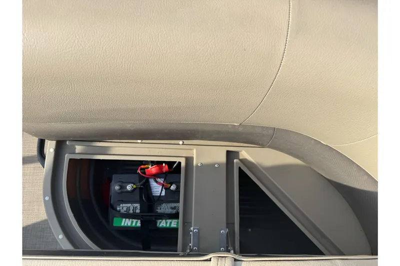 Slide: The Image of 2024 Sun Tracker Party Barge 16 DLX battery compartment with visible battery and wiring. - 13