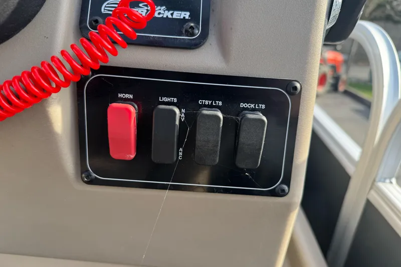 Slide: The Image of Control panel of 2024 Sun Tracker Party Barge 16 DLX with switches for horn and lights. - 18