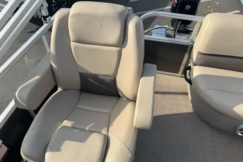 Slide: The Image of 2024 Sun Tracker Party Barge 16 DLX boat seat with beige upholstery and armrests. - 19