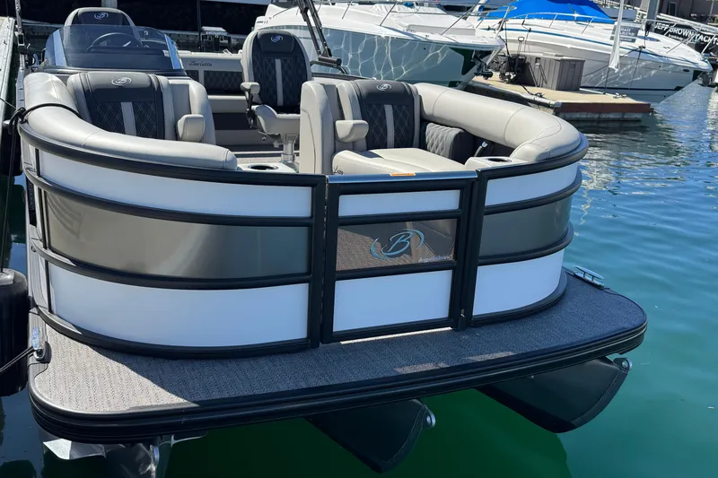 Slide: The Image of 2026 Barletta Lusso 23UC pontoon boat docked in marina, featuring luxurious seating. - 16