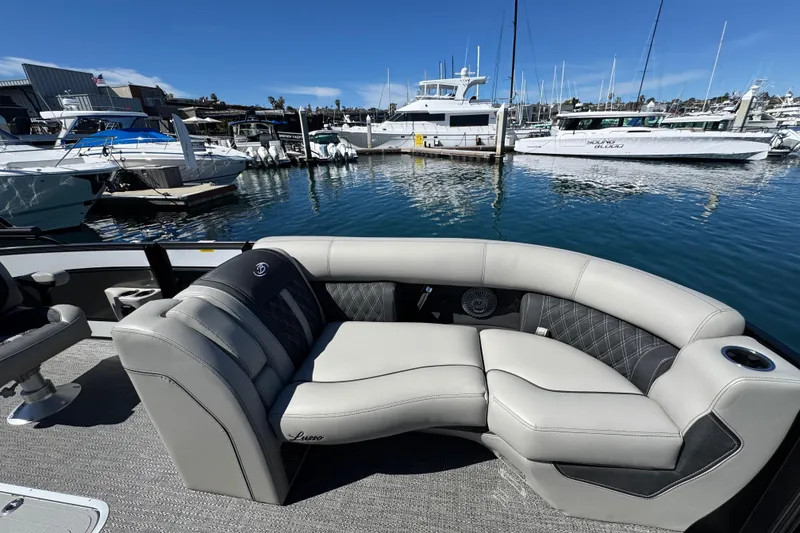 Slide: The Image of Luxurious 2026 Barletta Lusso 23UC pontoon boat interior at marina. - 20