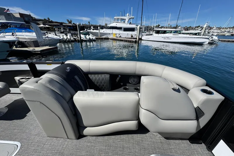 Slide: The Image of 2026 Barletta Lusso 23UC pontoon boat interior with luxurious seating at marina. - 22
