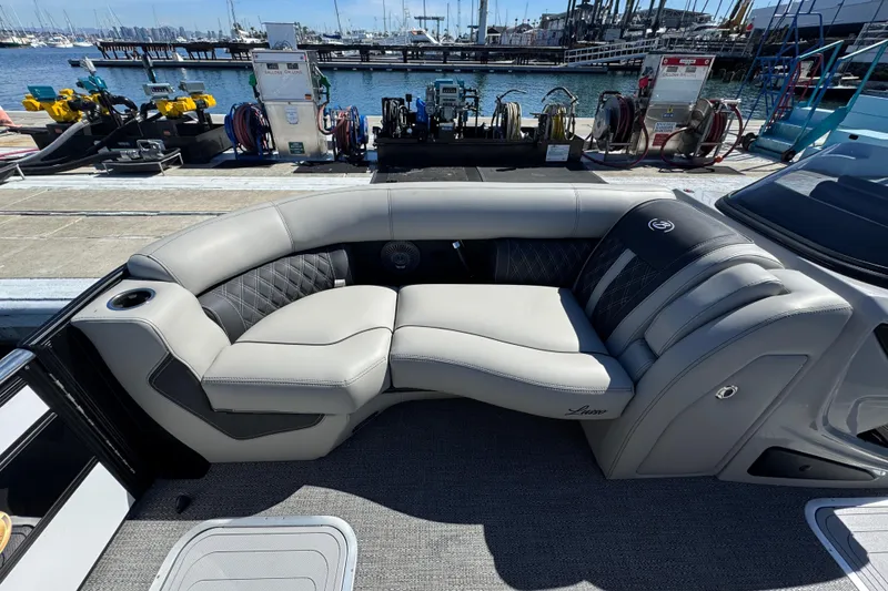 Slide: The Image of Luxurious seating on 2026 Barletta Lusso 23UC boat at marina dock. - 23