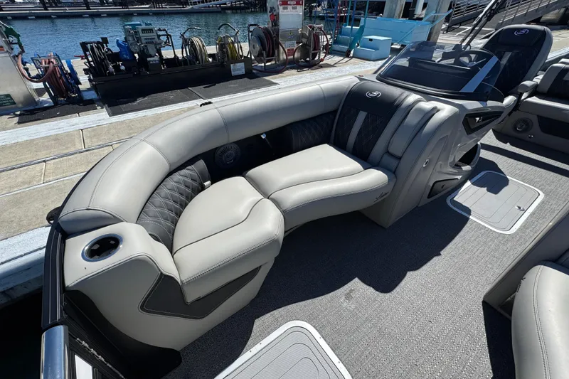 Slide: The Image of Luxurious seating on 2026 Barletta Lusso 23UC pontoon boat at dockside. - 24