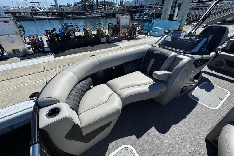 Slide: The Image of 2026 Barletta Lusso 23UC luxury boat interior with plush seating at marina. - 25