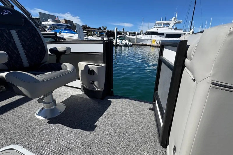 Slide: The Image of 2026 Barletta Lusso 23UC pontoon boat interior with luxurious seating at marina. - 37