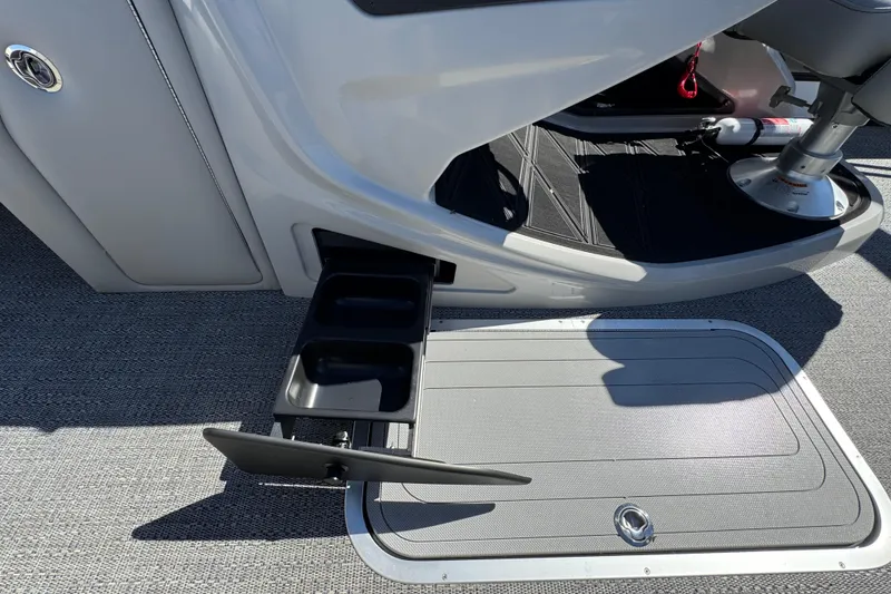 Slide: The Image of 2026 Barletta Lusso 23UC boat interior with cup holder and storage compartment. - 44
