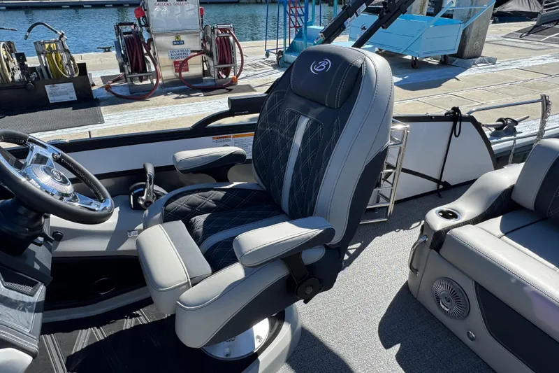 Slide: The Image of Captain's chair on 2026 Barletta Lusso 23UC pontoon boat at marina. - 45