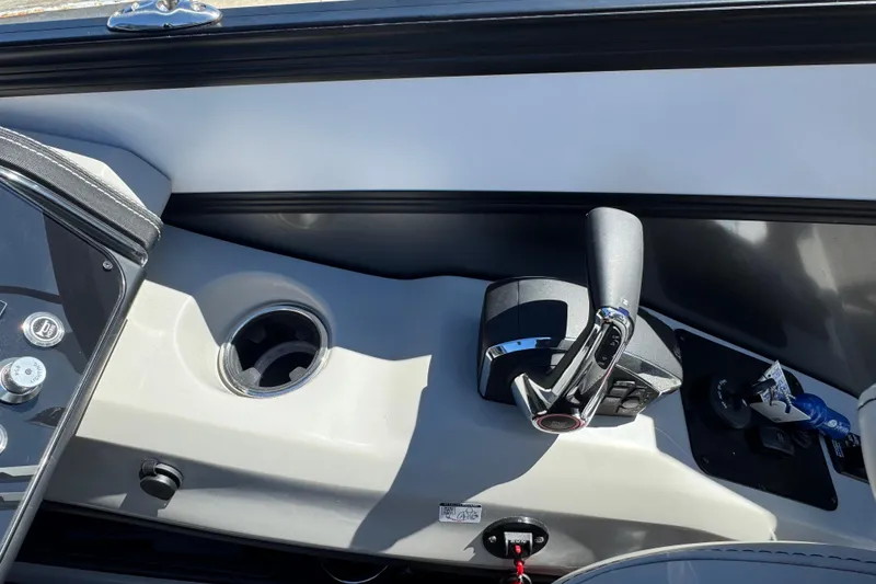 Slide: The Image of Control panel of 2026 Barletta Lusso 23UC boat with throttle and cup holder. - 48