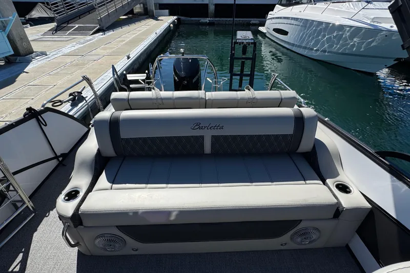 Slide: The Image of 2026 Barletta Lusso 23UC boat with luxurious seating at a marina dock. - 50