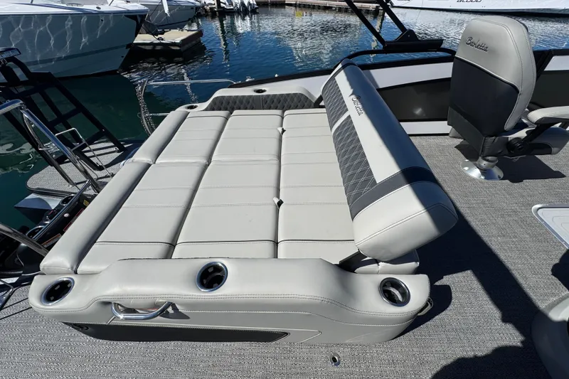Slide: The Image of 2026 Barletta Lusso 23UC boat interior with luxurious seating and cup holders. - 54