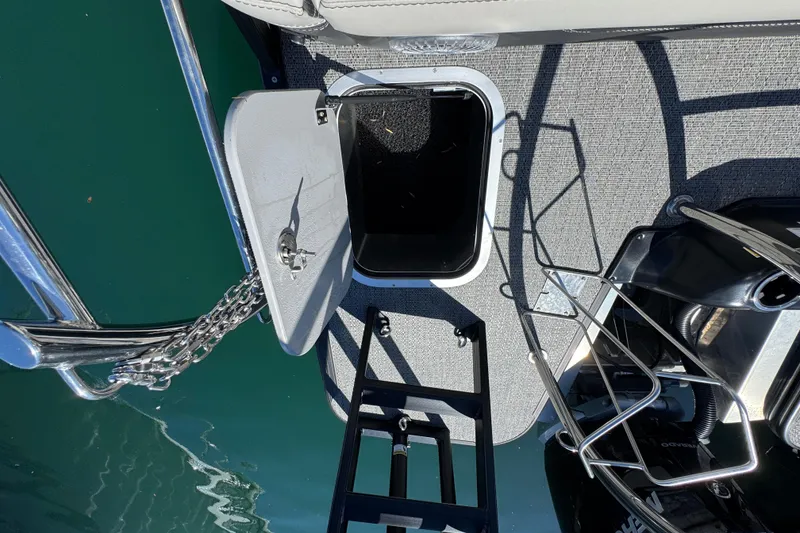 Slide: The Image of Open hatch on 2026 Barletta Lusso 23UC pontoon boat deck, showing storage compartment. - 61