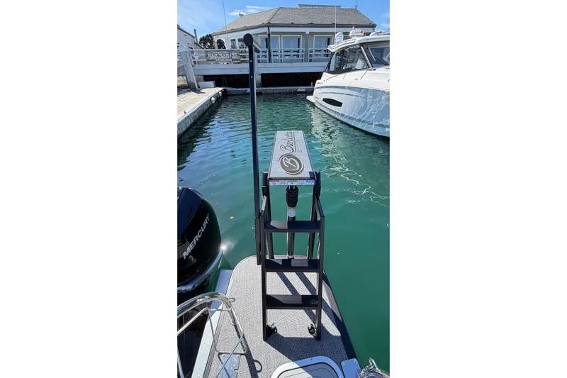 Slide: The Image of 2026 Barletta Lusso 23UC pontoon boat docked at marina with clear water. - 63