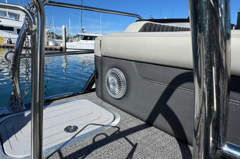 Slide: The Image of 2026 Barletta Lusso 23UC boat interior with speaker, docked at marina. - 65