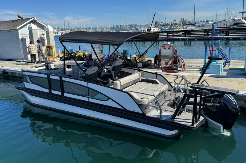 Slide: The Image of 2026 Barletta Lusso 23UC pontoon boat docked at marina with Mercury engine. - 78
