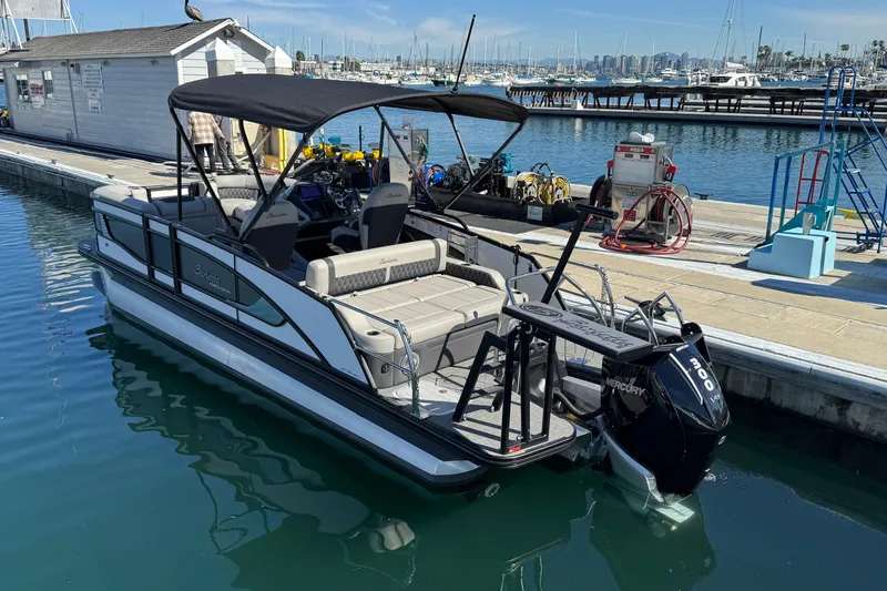 Slide: The Image of 2026 Barletta Lusso 23UC pontoon boat docked at a marina with Mercury outboard engine. - 79