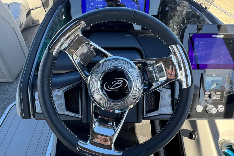 Slide: The Image of Steering wheel of 2026 Barletta Lusso 23UC boat with modern dashboard controls. - 86