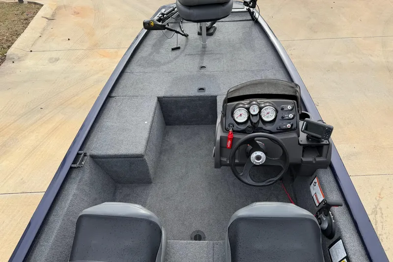 Slide: The Image of 2022 Bass Tracker Pro 170 boat interior with steering console and seating. - 6