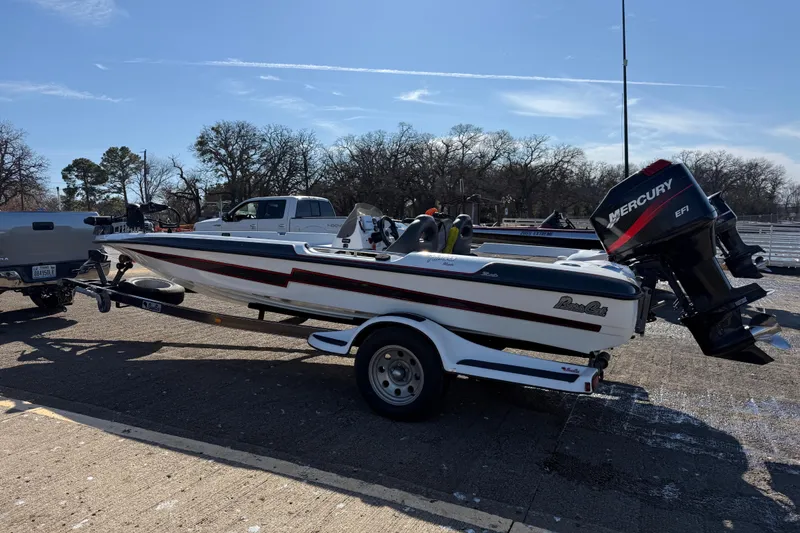 Slide: The Image of 2005 Bass Cat Pantera Classic boat on trailer with Mercury engine, parked outdoors. - 10