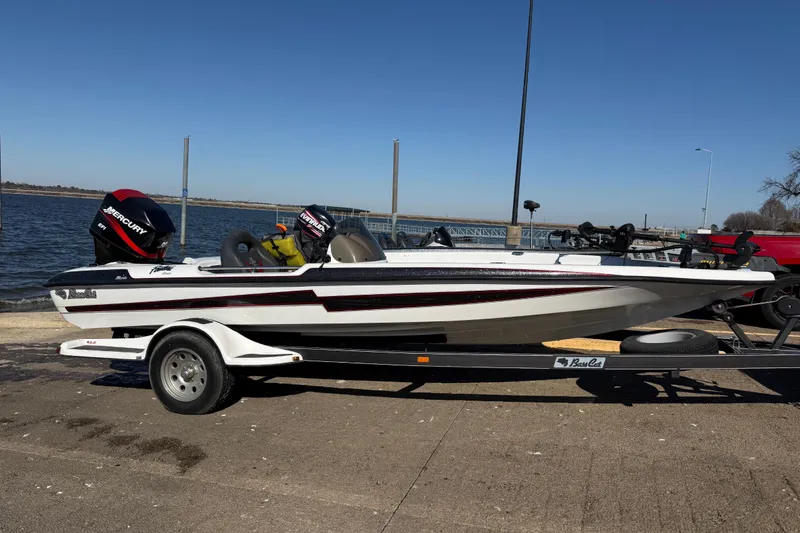 Slide: The Image of 2005 Bass Cat Pantera Classic boat on trailer by the water. - 3