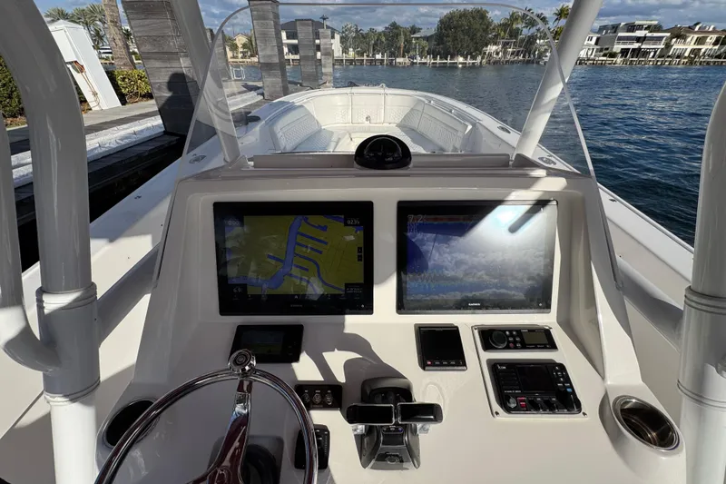Slide: The Image of 2017 Intrepid 375 Center Console boat dashboard with navigation screens and controls. - 11