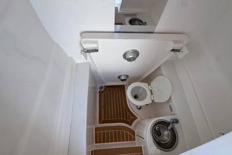 Slide: The Image of 2017 Intrepid 375 Center Console boat bathroom with toilet and sink. - 15