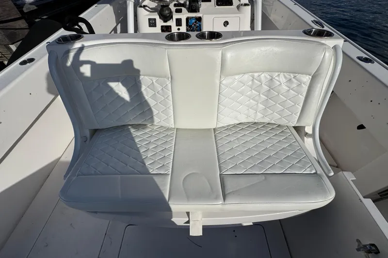 Slide: The Image of 2017 Intrepid 375 Center Console boat with white quilted seating and cup holders. - 16