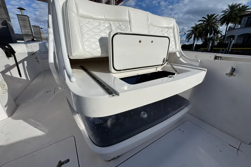 Slide: The Image of 2017 Intrepid 375 Center Console boat with open storage compartment, palm trees in background. - 17