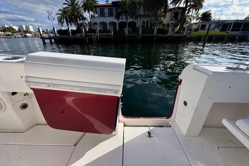 Slide: The Image of 2017 Intrepid 375 Center Console boat with open transom door, dockside view. - 18